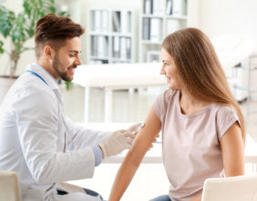 pharmacist injecting woman